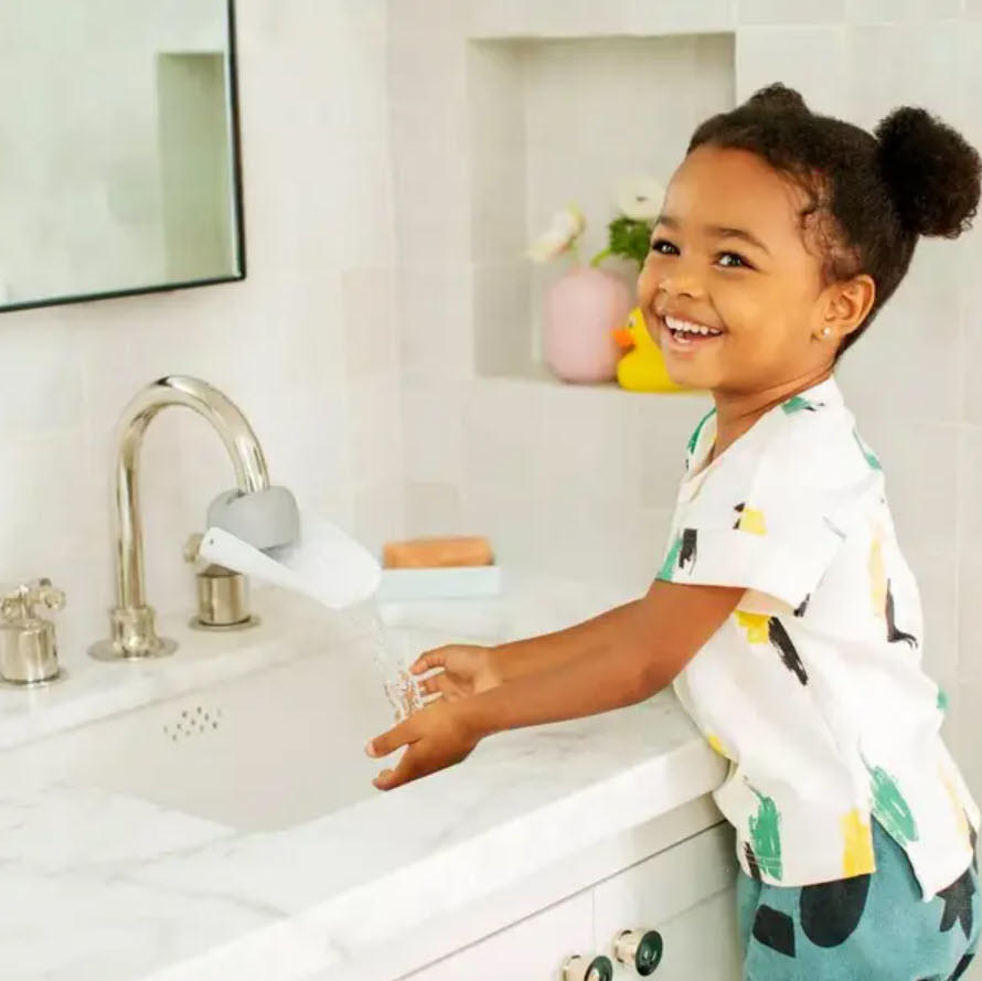 kid using open spout and washing hands at sink