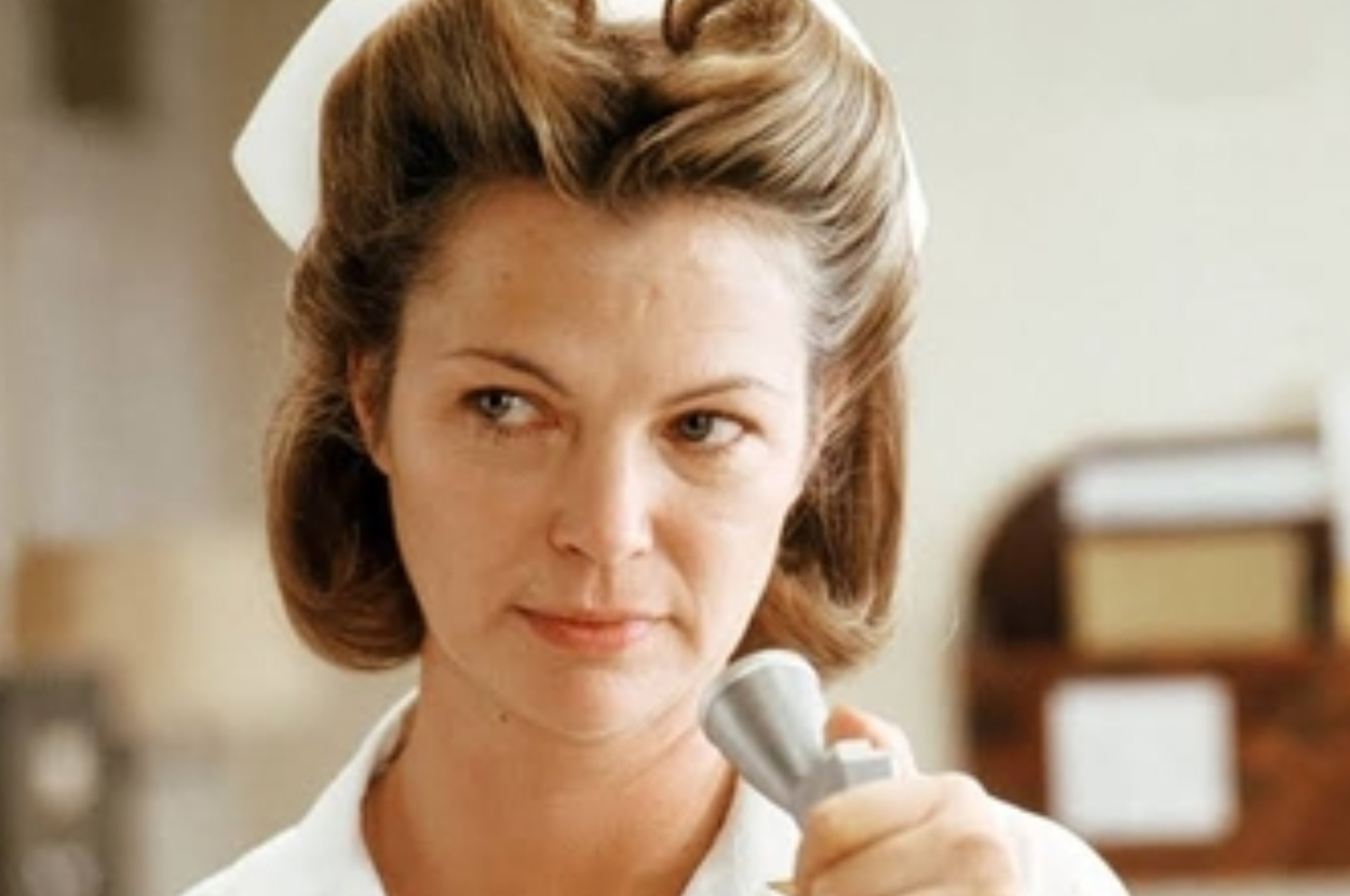 Woman in a nurse&#x27;s uniform holding a medical instrument
