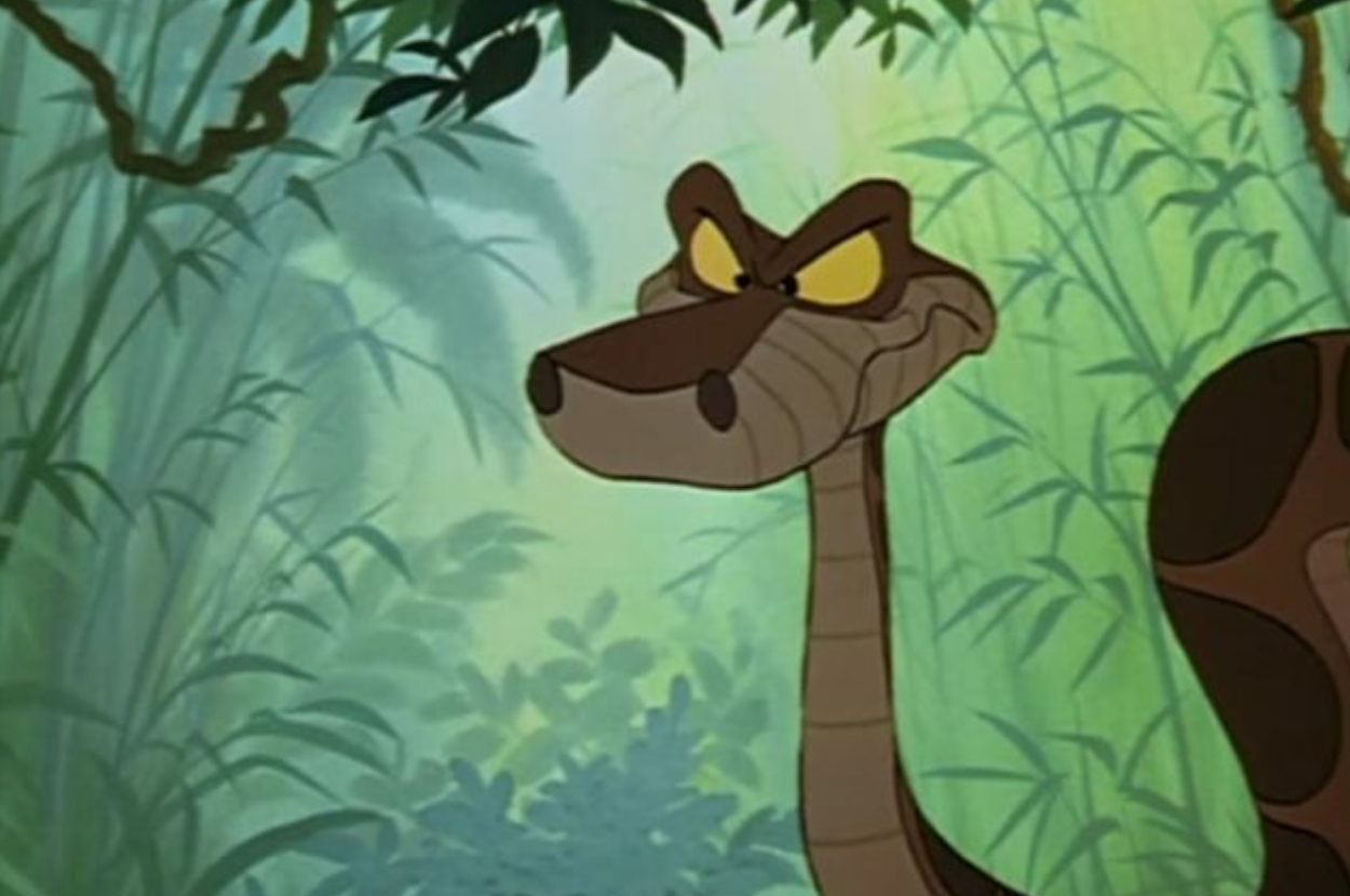 Kaa from The Jungle Book appears suspicious with a slight grin in a jungle setting