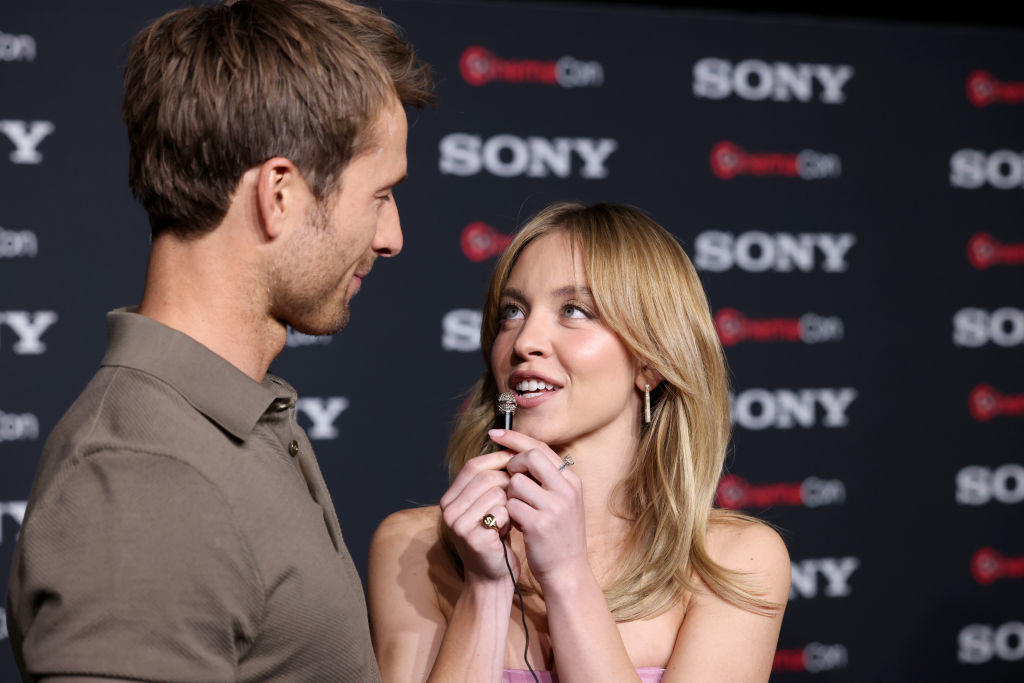 Two celebrities facing each other, man in casual shirt, woman in strapless outfit, at a Sony event