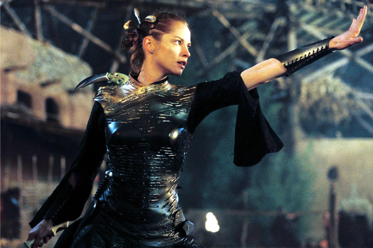Character in a metallic costume with arm extended, portraying a sci-fi warrior stance