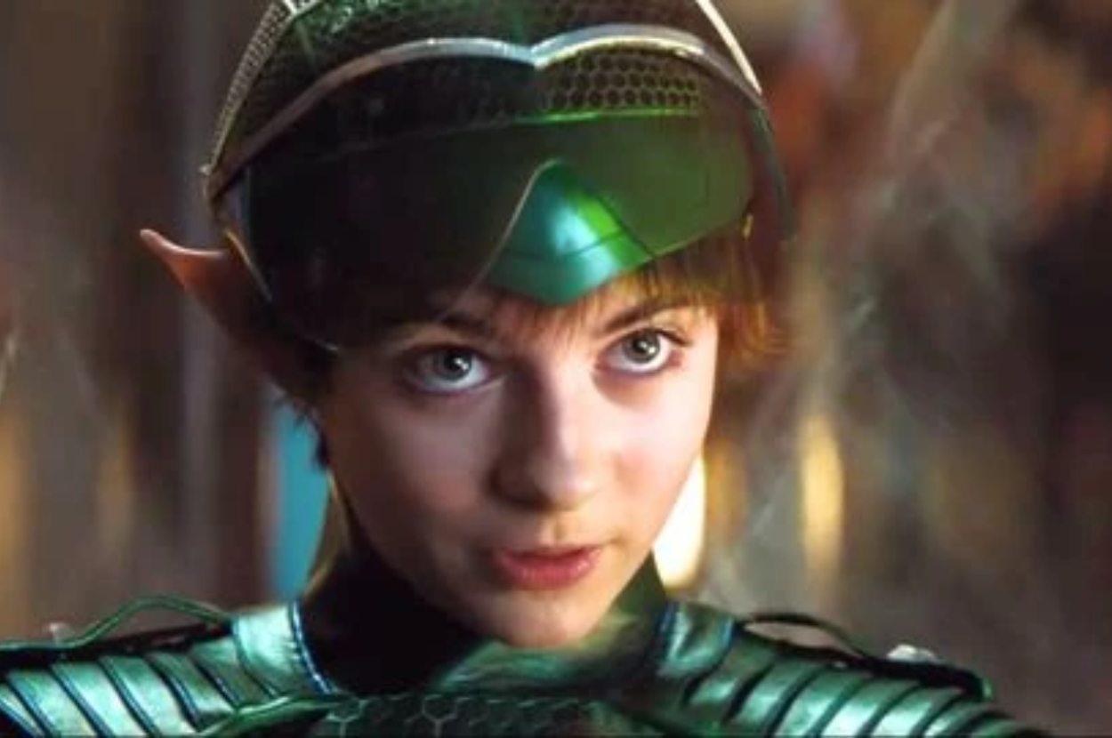 Character wearing a green costume and headpiece with elf-like ears