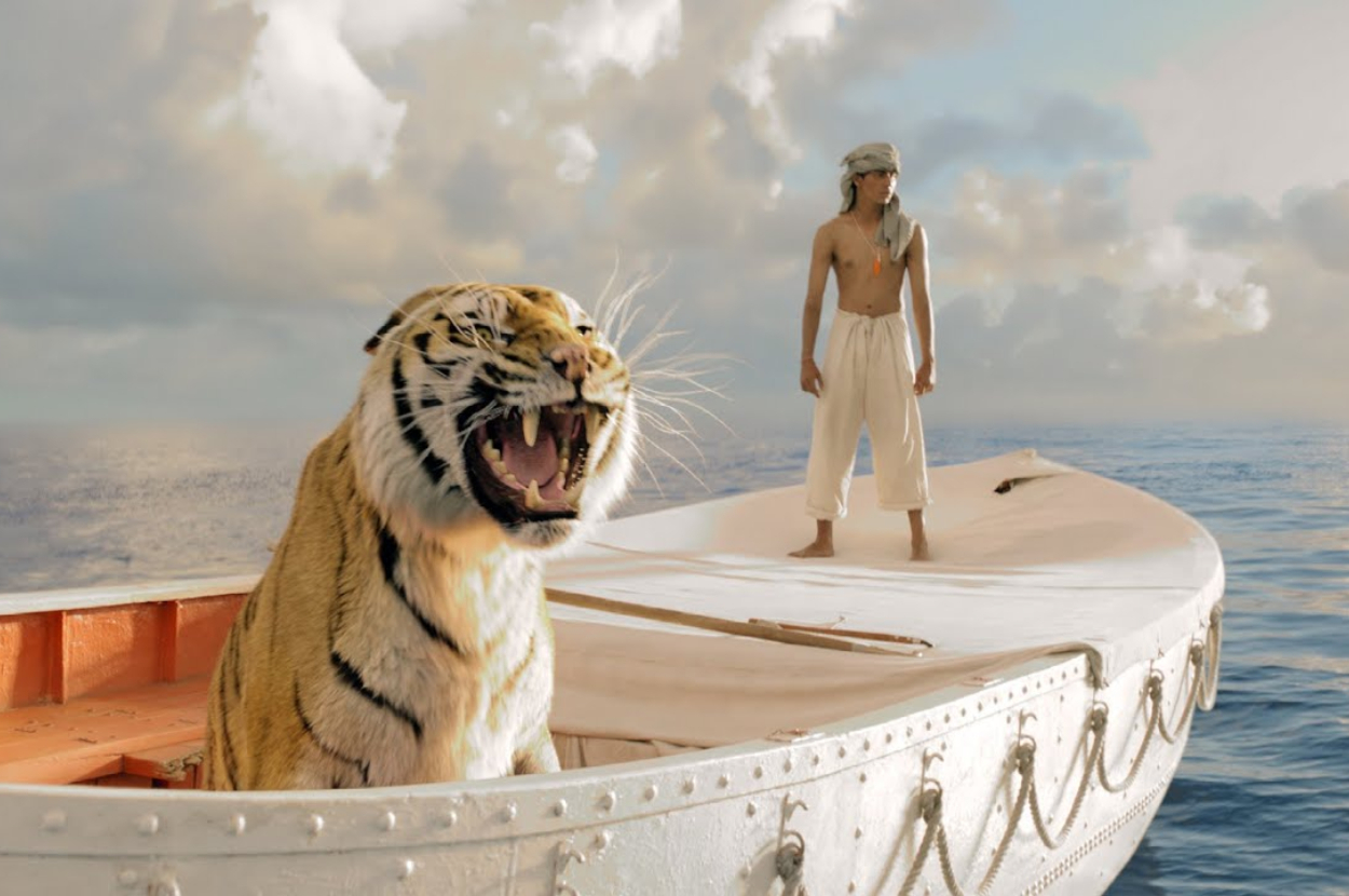 A person and a tiger on a boat, likely a scene from the story &quot;Life of Pi.&quot;