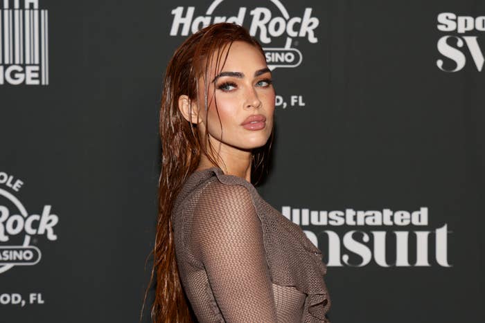 Megan Fox wearing a mesh dress at a Sports Illustrated event
