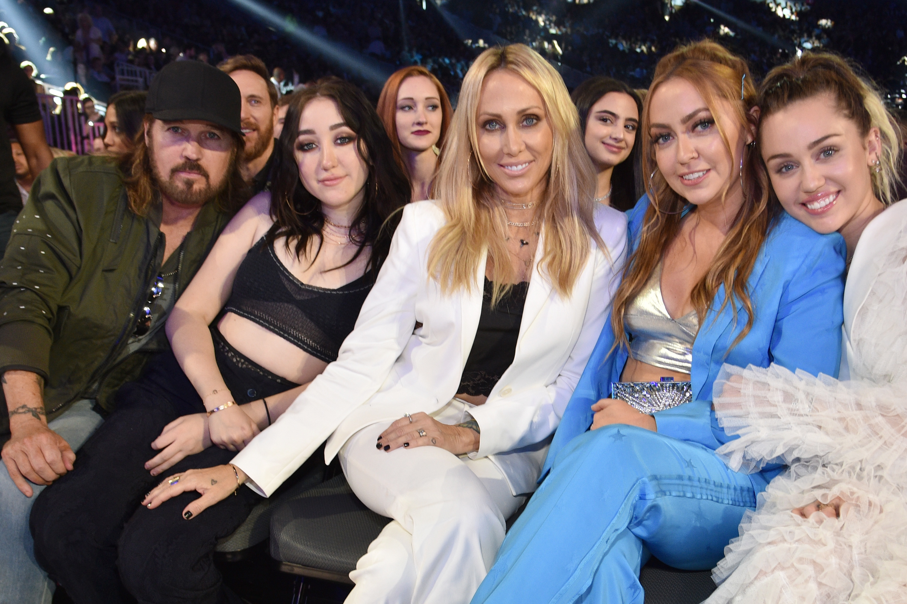 Billy Rae and Tish sitting with their three daughters at an event