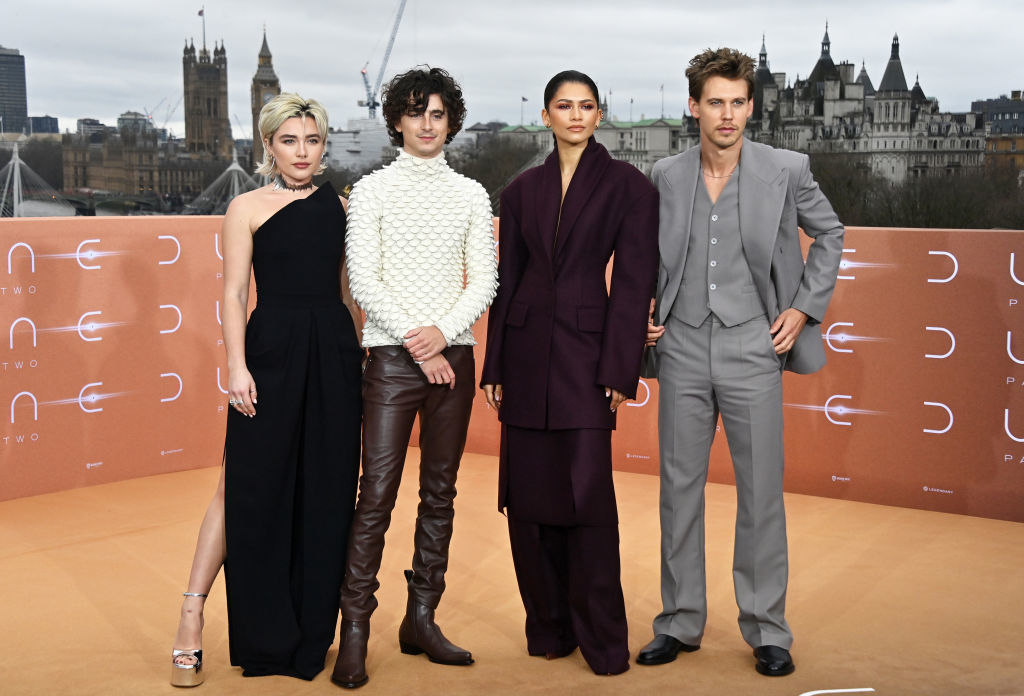 Florence, Timothée, Zendaya, and Austin pose at an event with London skyline in the background