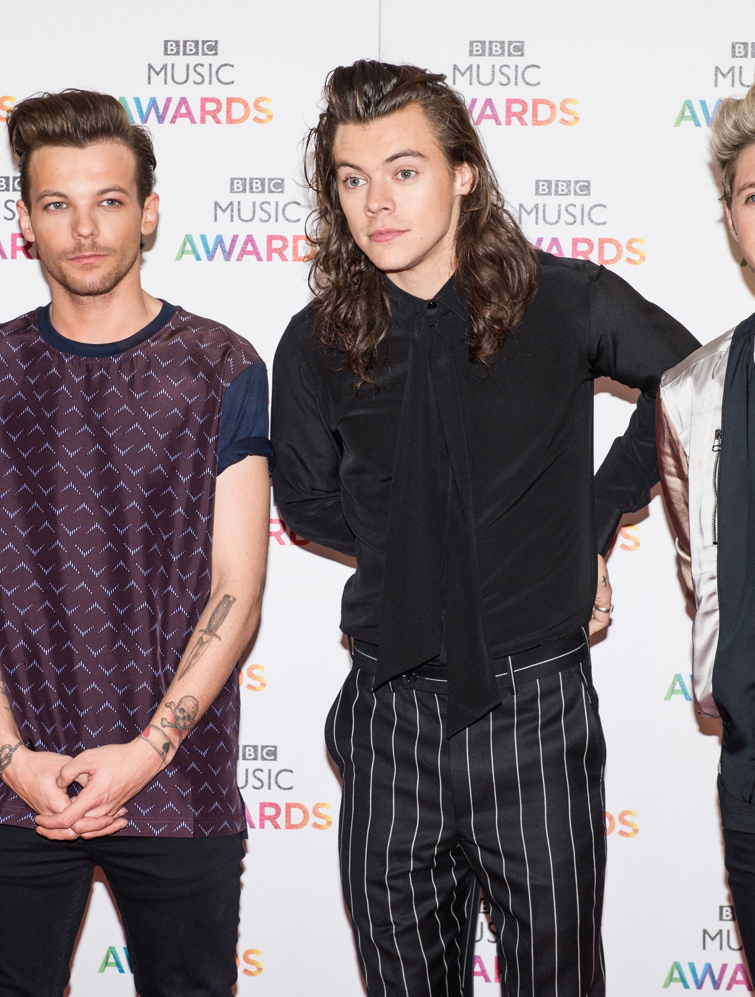 on the red carpet, Harry and Louis stand apart