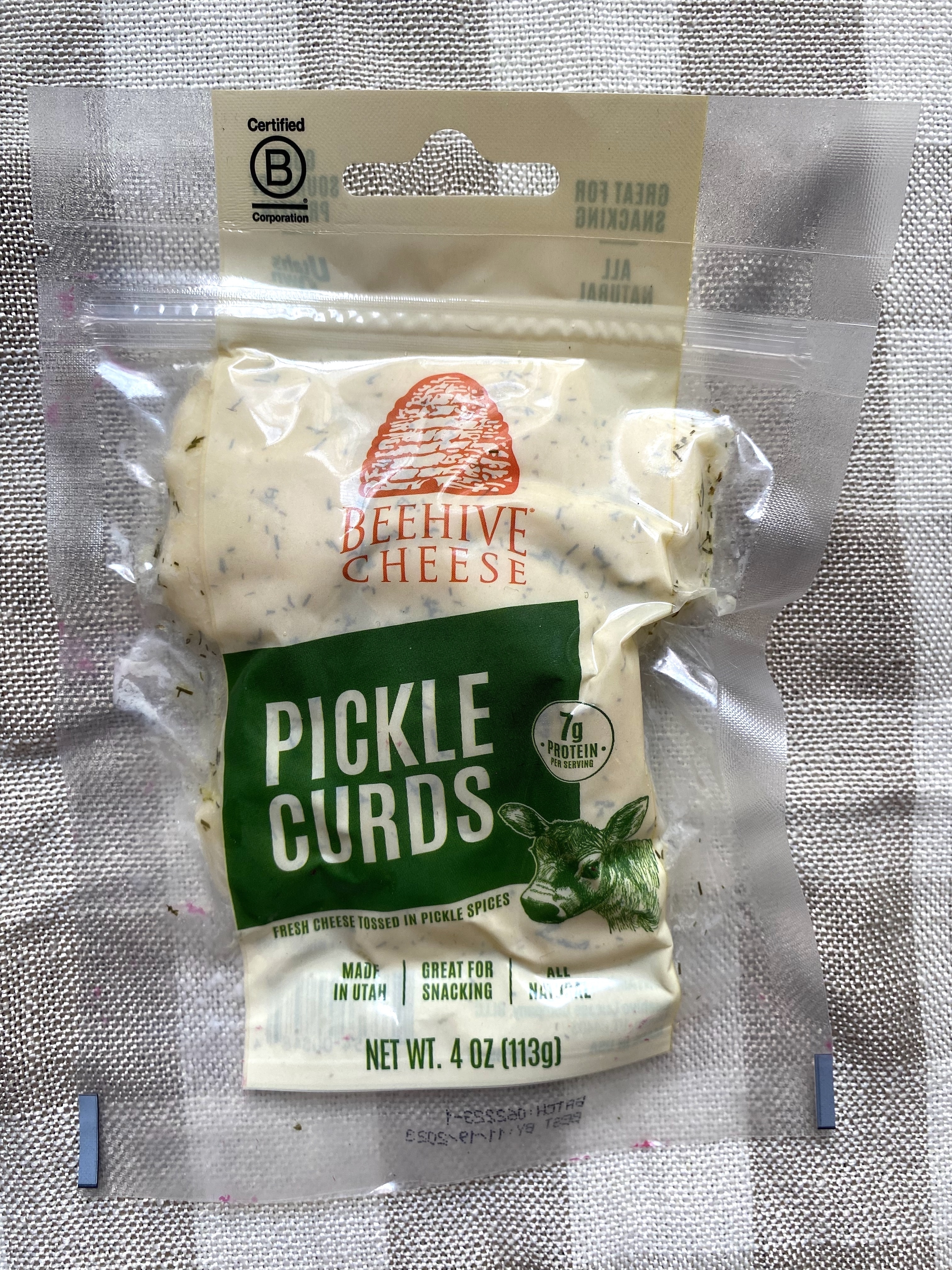 Package of Beehive Cheese Pickle Curds on a textured background