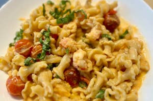 bowl of pasta with lobster and cherry tomatoes