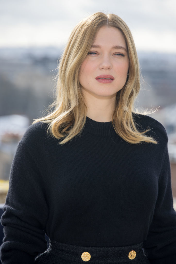 Léa in a black top with button details, looking to the side