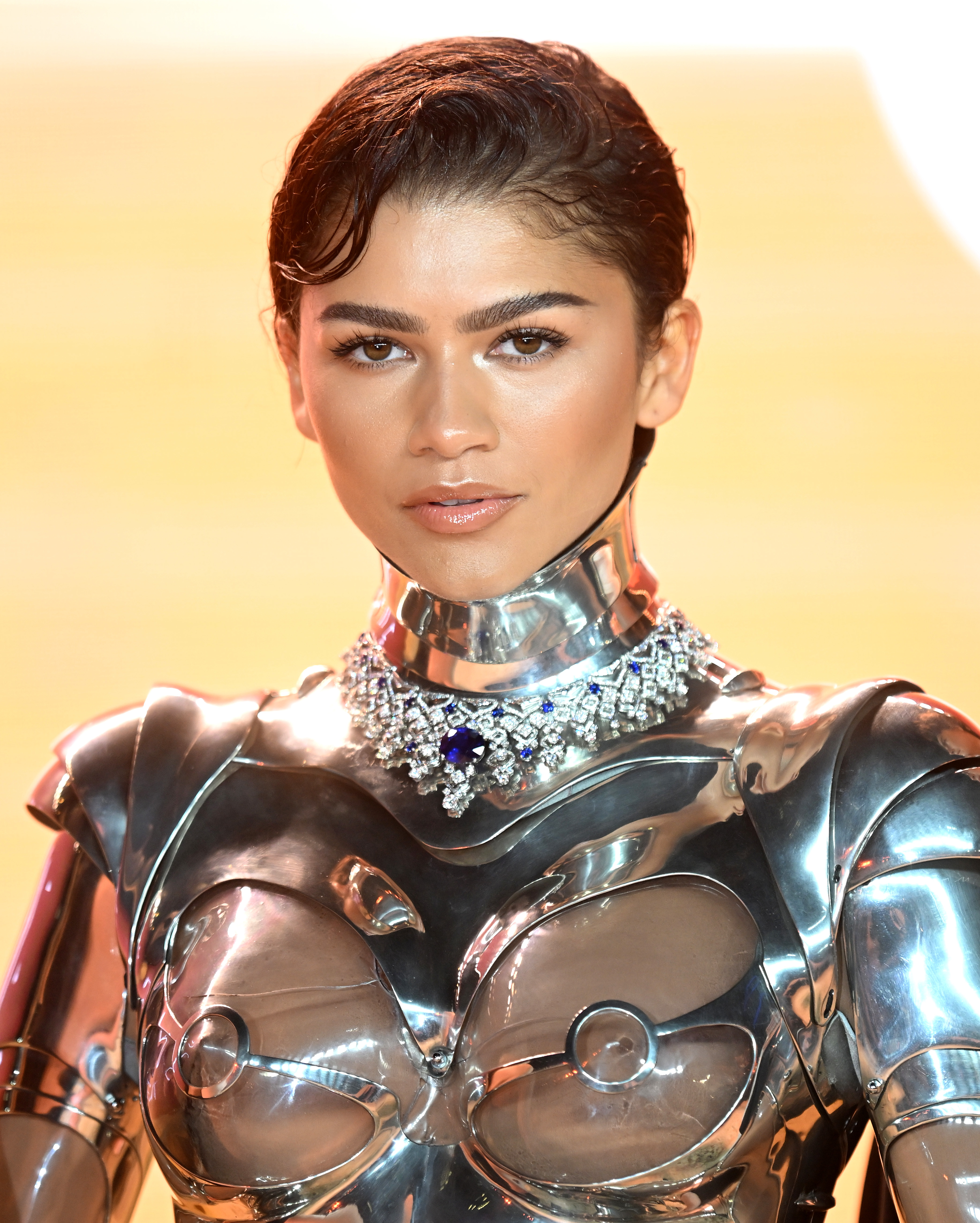 Zendaya in futuristic metallic outfit with statement necklace