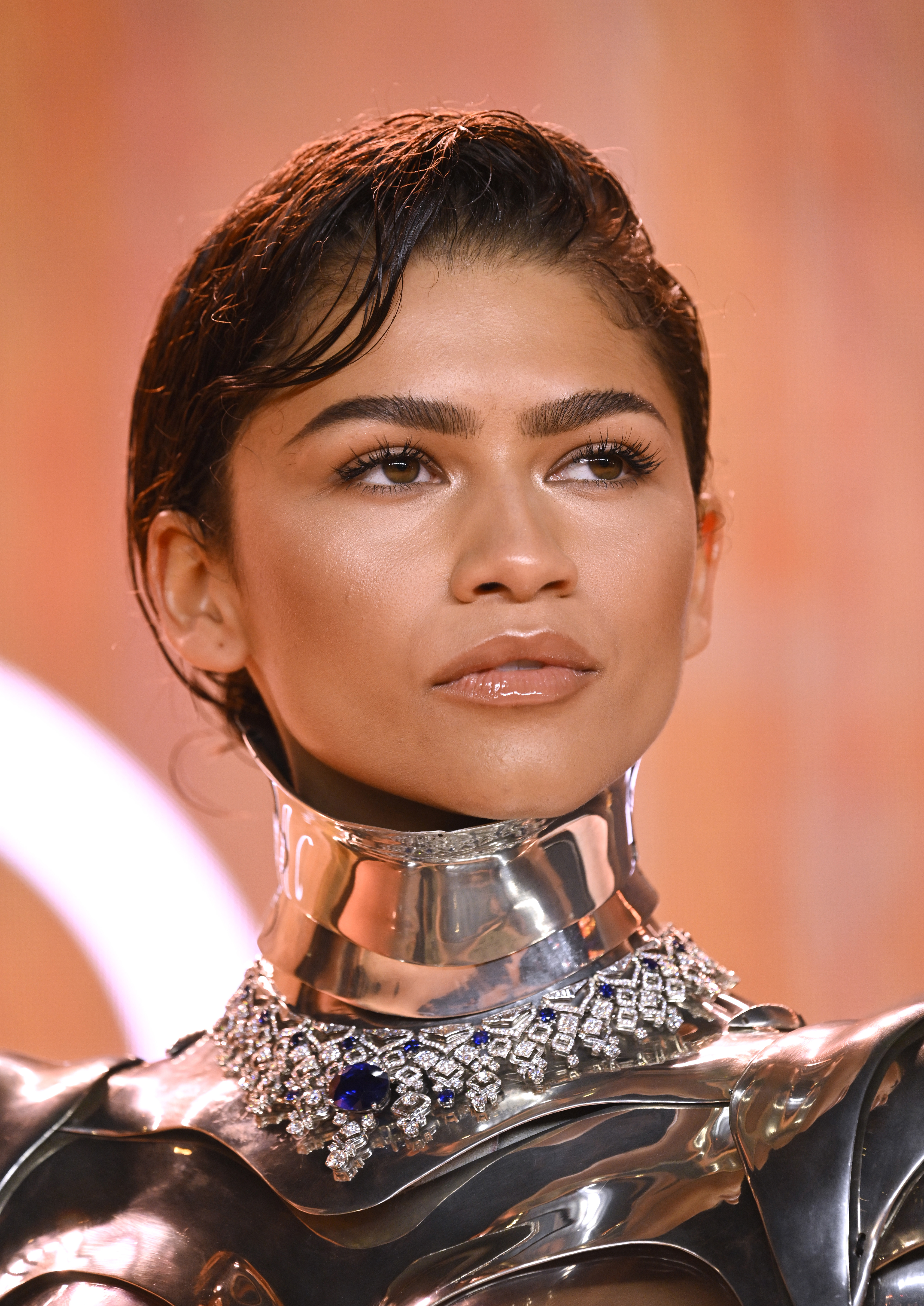 Zendaya wearing a metallic outfit with an ornate collar necklace