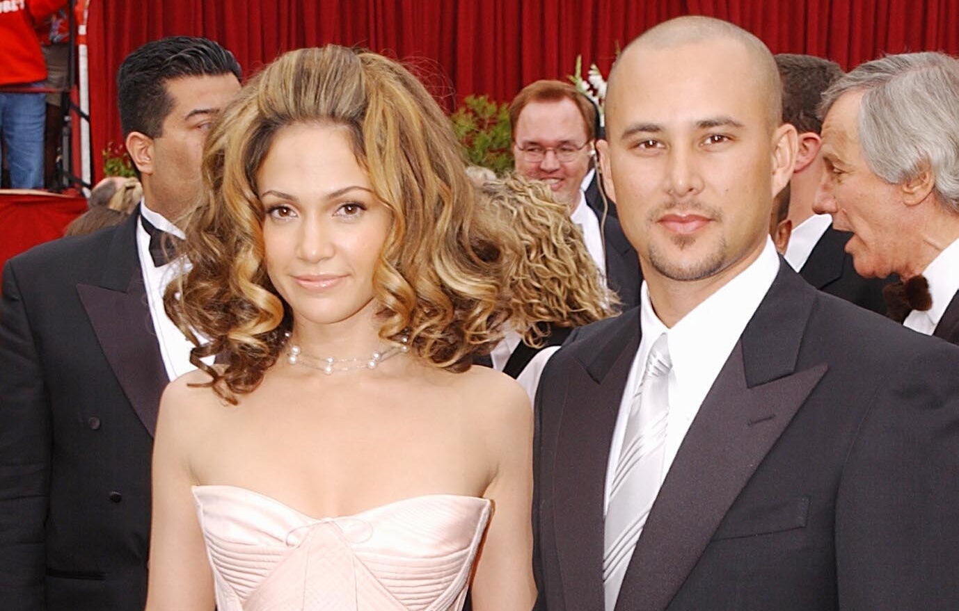 Jennifer Lopez in a strapless gown with Cris Judd in a suit on the red carpet