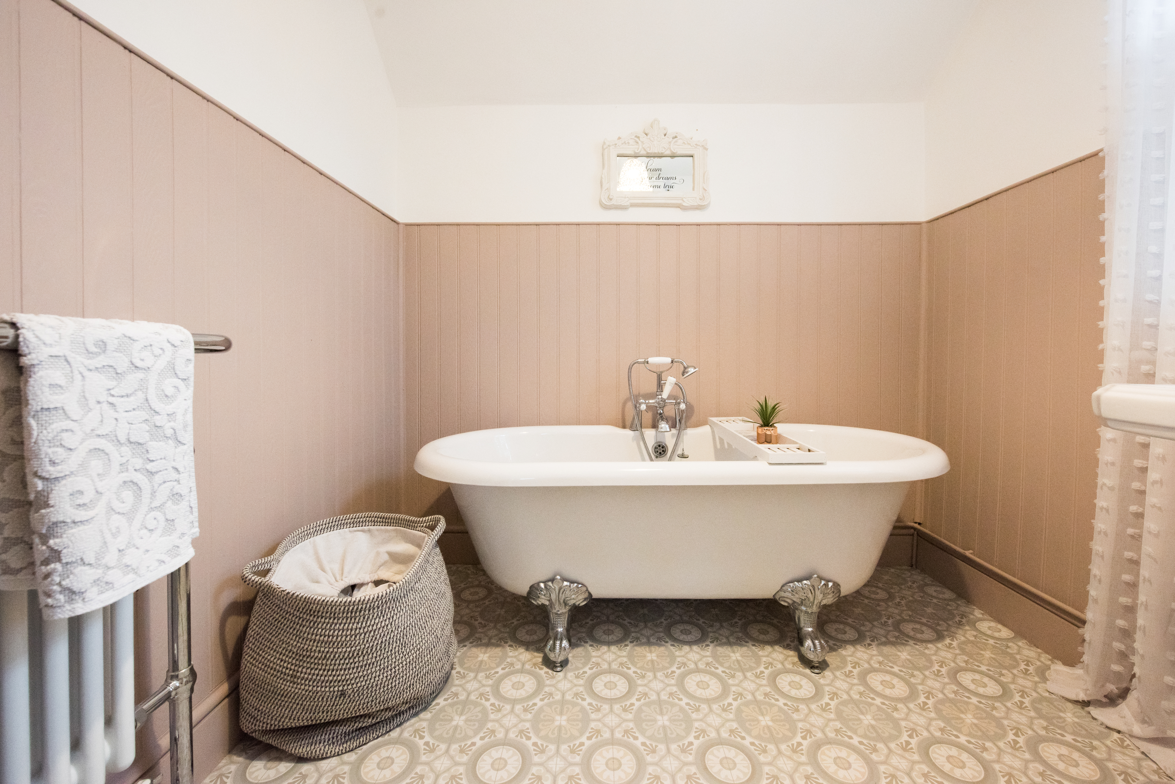 A claw-foot tub in a cozy bathroom setting