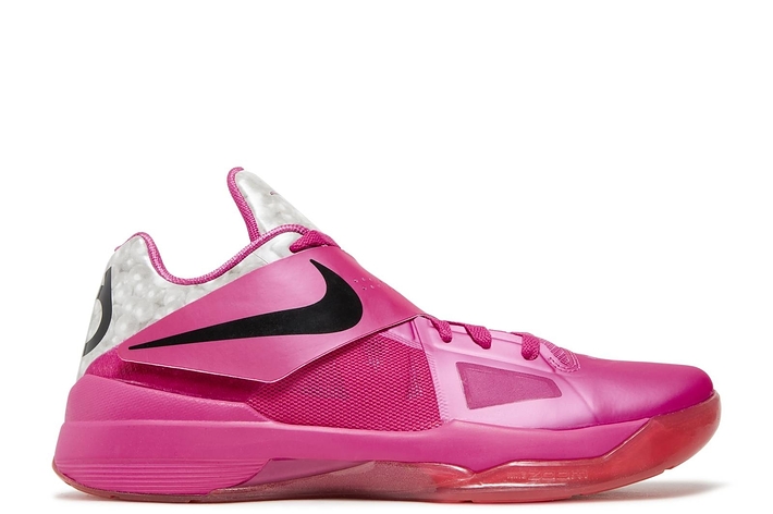 A single bright pink Nike basketball sneaker with dotted inner lining, prominent swoosh logo, and air cushioned heel