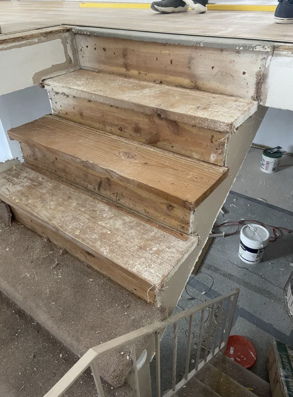 A set of wooden stairs under construction with removed treads, revealing risers and stringers