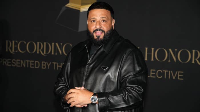 DJ Khaled in a black jacket posing at an event