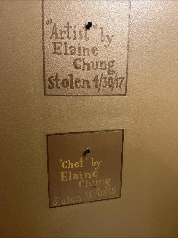 Two plaques indicating artwork by Elaine Chung with titles "Artist" and "Chef" and dates