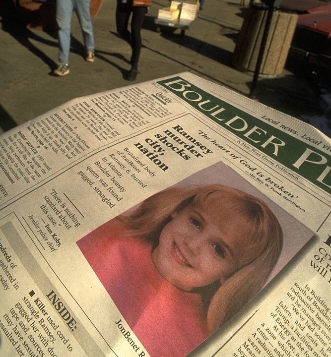 A newspaper headline about JonBenet Ramsey with a photo of her and article text