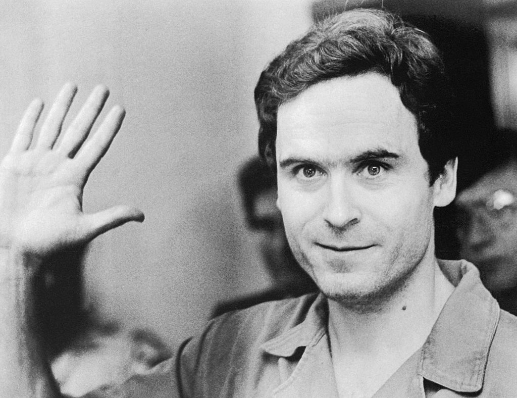 Ted Bundy waving, wearing a short-sleeved shirt