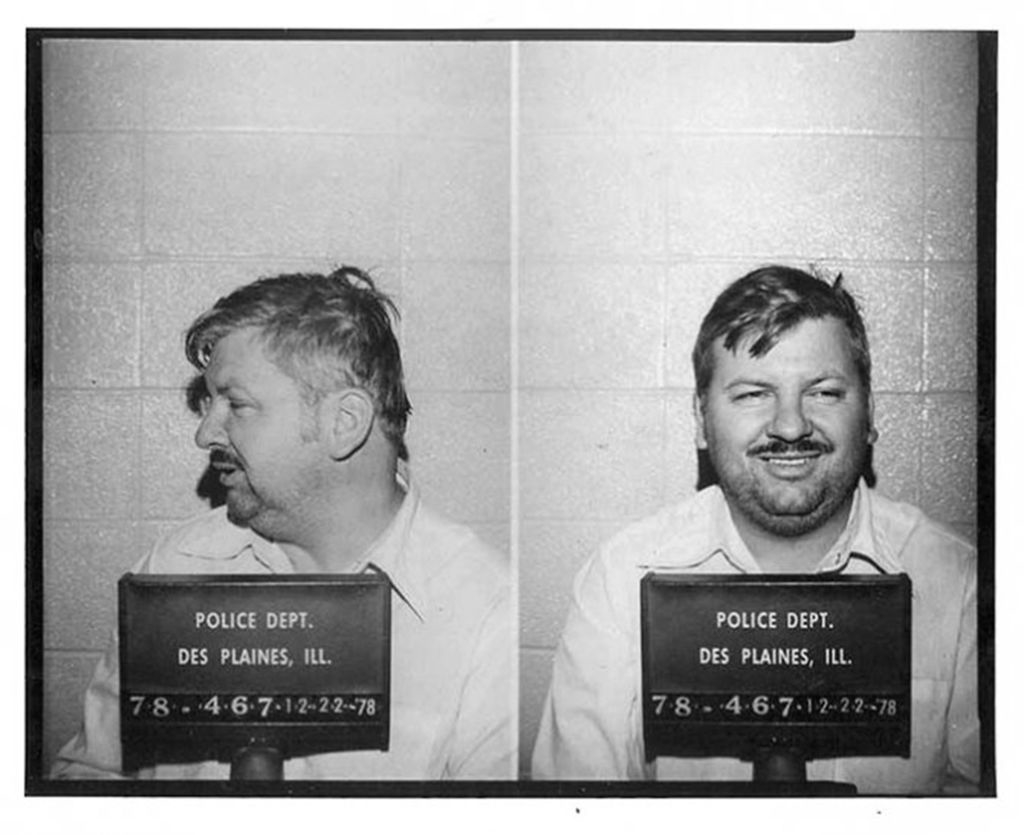 Mugshots of John Wayne Gacy smiling, front and profile views, with placards showing dates and police department info
