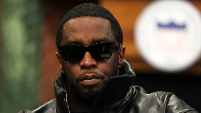 Diddy wearing sunglasses and leather outfit