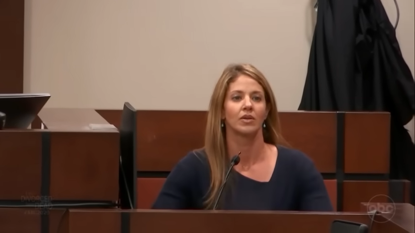 Wendi Adelson is sitting at a witness stand in a courtroom