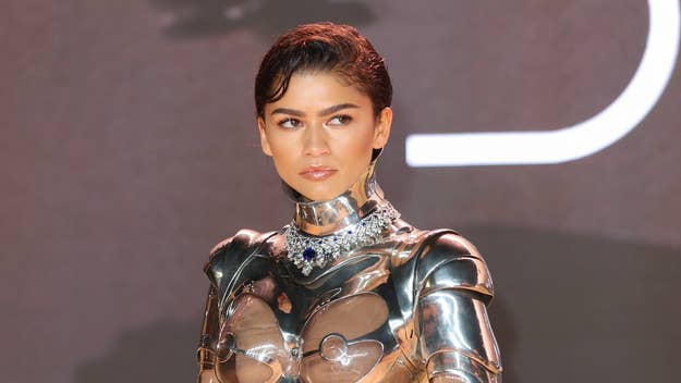 Person in a futuristic metallic outfit with a structured silhouette and collar detail