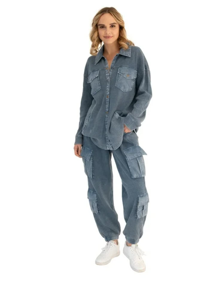 model in denim patchwork jumpsuit and white sneakers