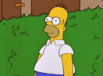 Homer Simpson standing in front of bushes, looking surprised with eyes wide open