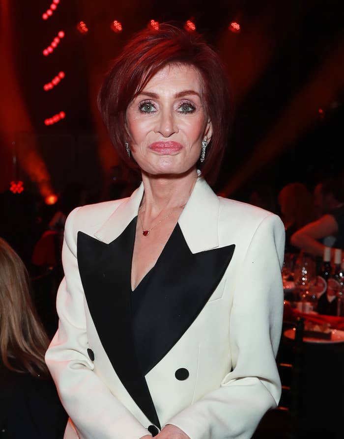 Sharon Osbourne in a white blazer with black lapels and accents, attending a formal event