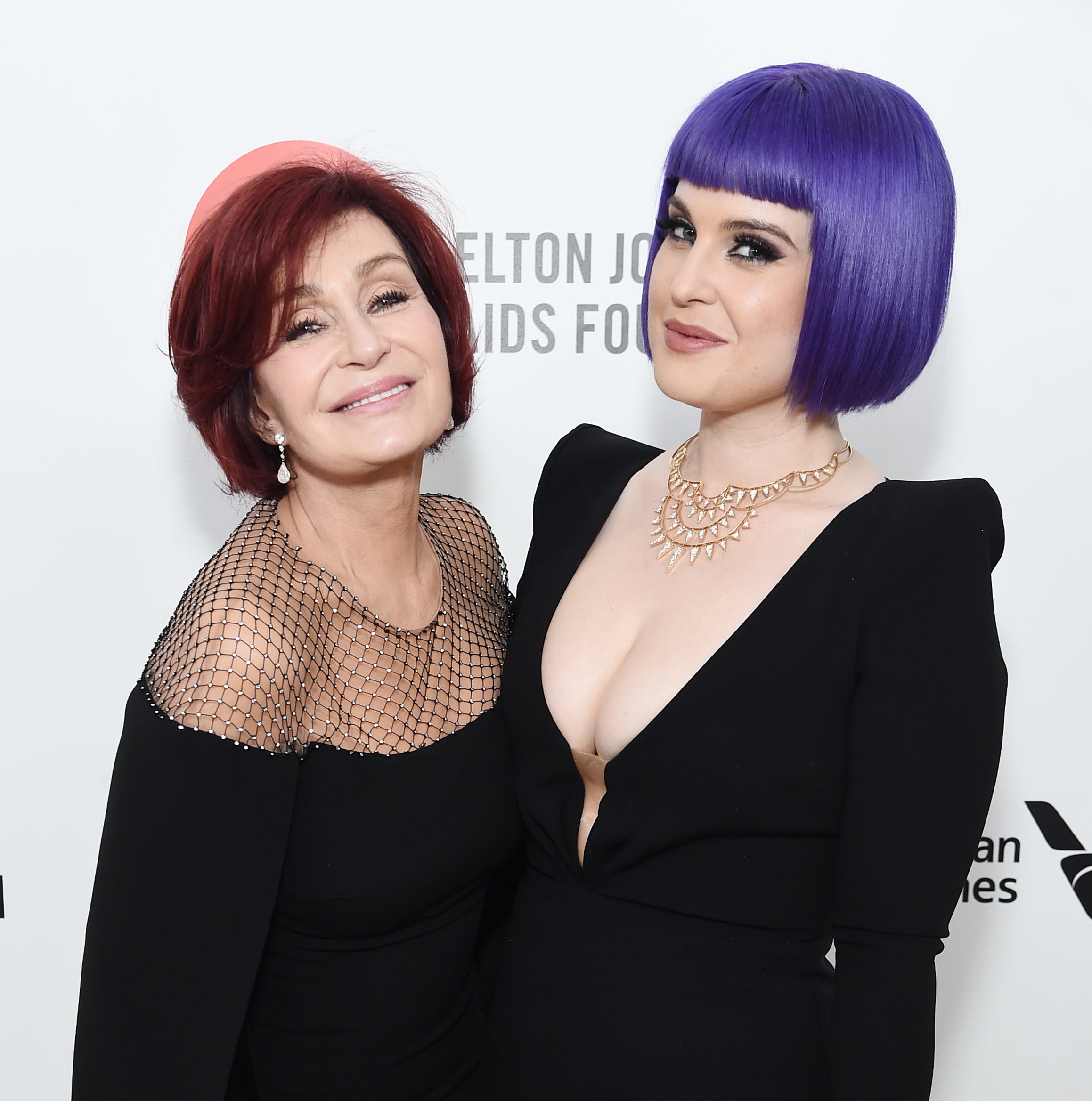 Sharon and Kelly Osbourne posing at a media event