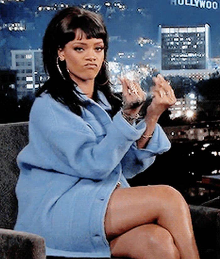 Rihanna pinching her fingers together to indicate lots of money