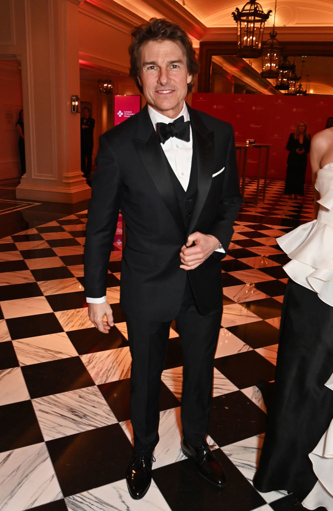 Tom in a classic black tuxedo with a bow tie at a formal event