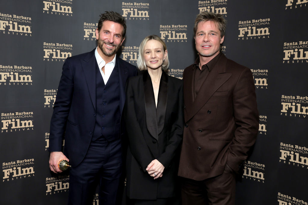 Brad smiling and standing with Bradley Cooper and Carey Mulligan at the Santa Barbara Film Festival; all wearing suits