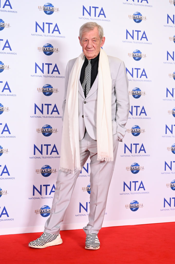 Ian in a light suit with a striped scarf and black-and-white sneakers at the National Television Awards