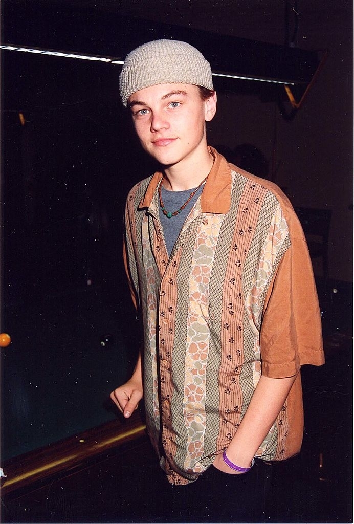 Leo in a beanie and patterned button-down shirt posing for the camera