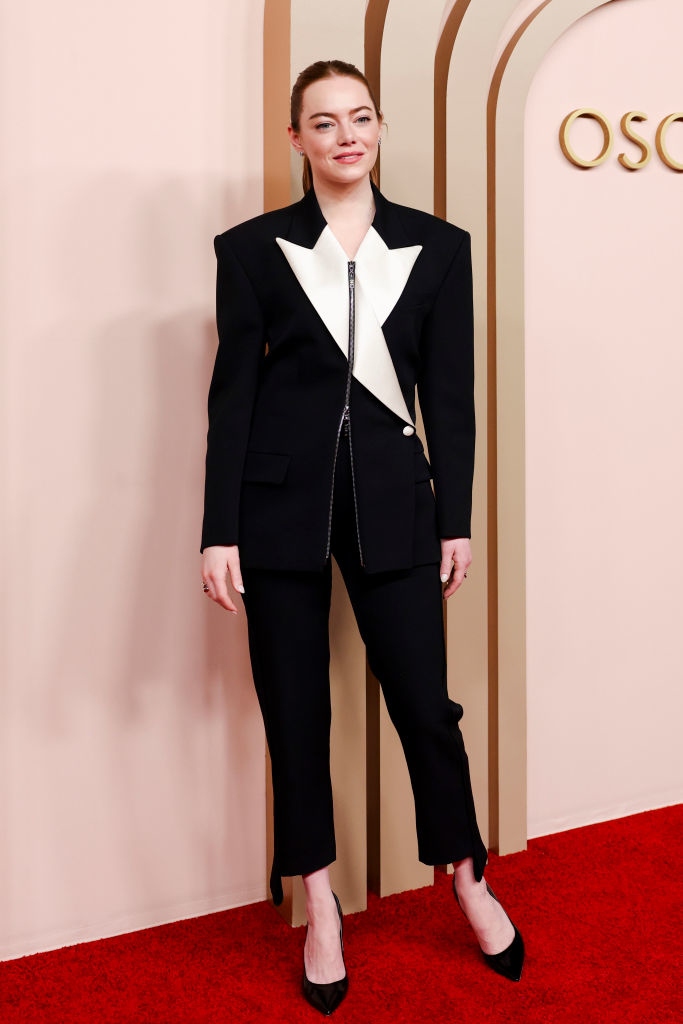Emma in a black-and-white asymmetrical blazer and trousers on the Oscars red carpet
