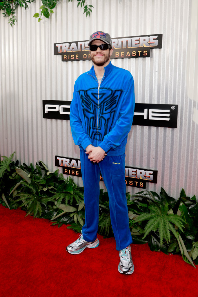Pete wearing a blue tracksuit with logo, sunglasses, and sneakers at Transformers premiere