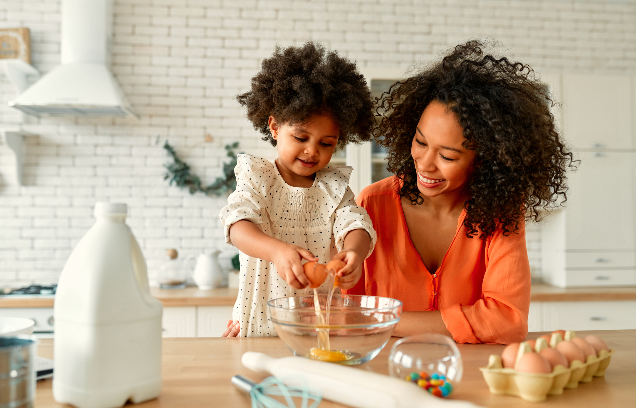 Mother and child happily baking together in a kitchen