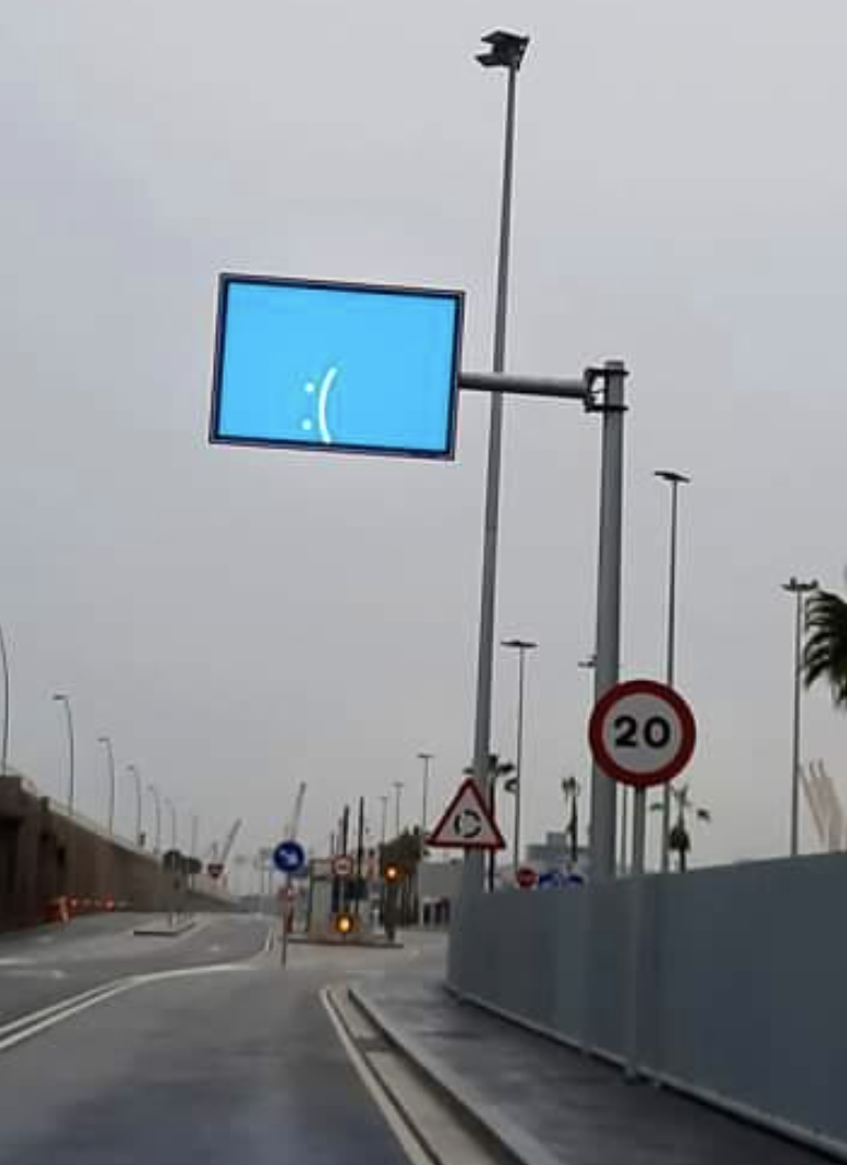 Digital street sign with a sad face