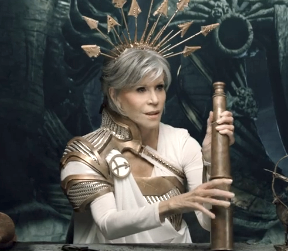 Jane Fonda in a sci-fi costume with a spiked crown and metallic arm pieces