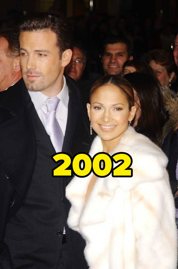 the two in 2002, ben in a suit with a tie, and jen in a white fur coat