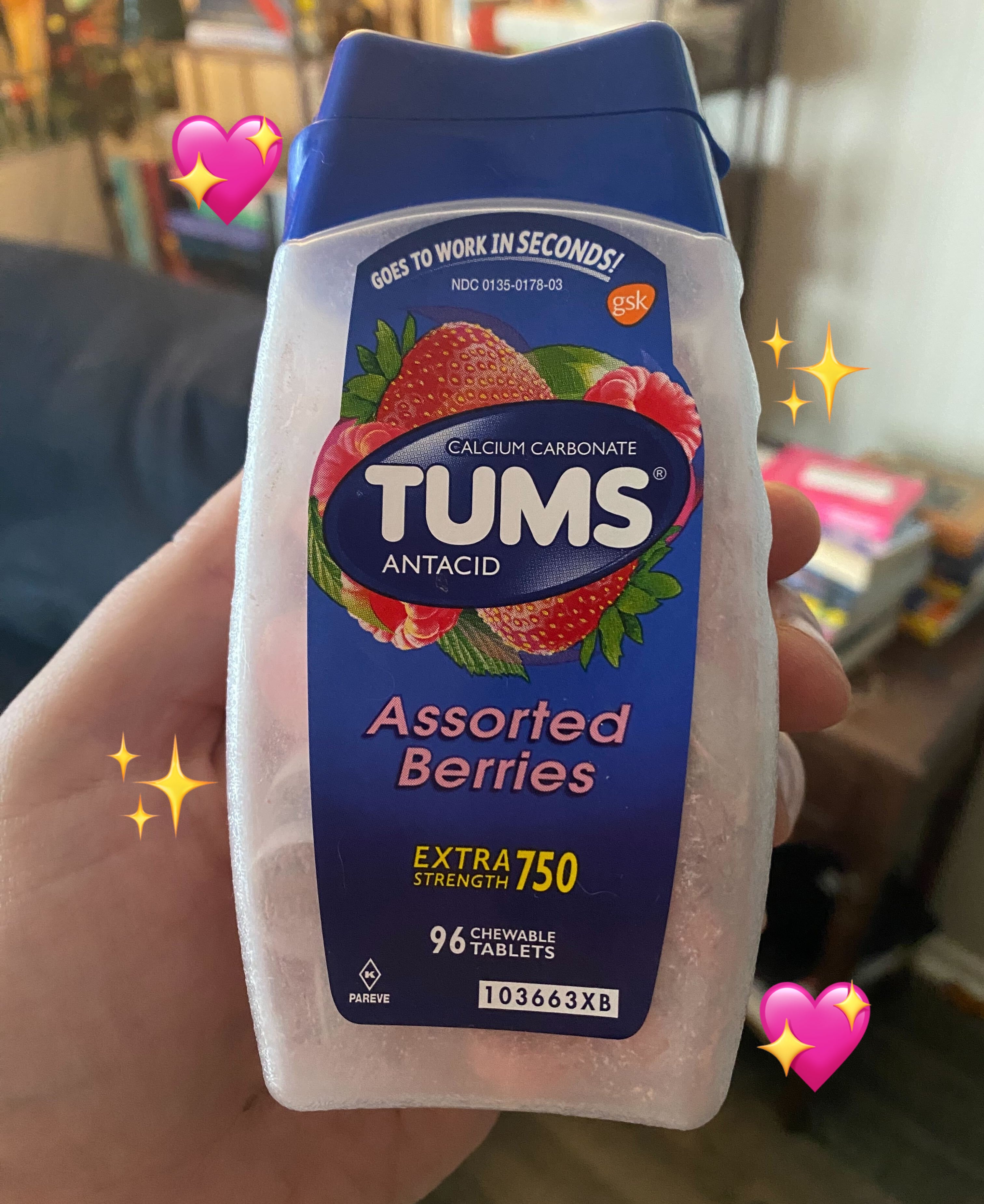 Hand holding a bottle of Tums Assorted Berries antacid tablets