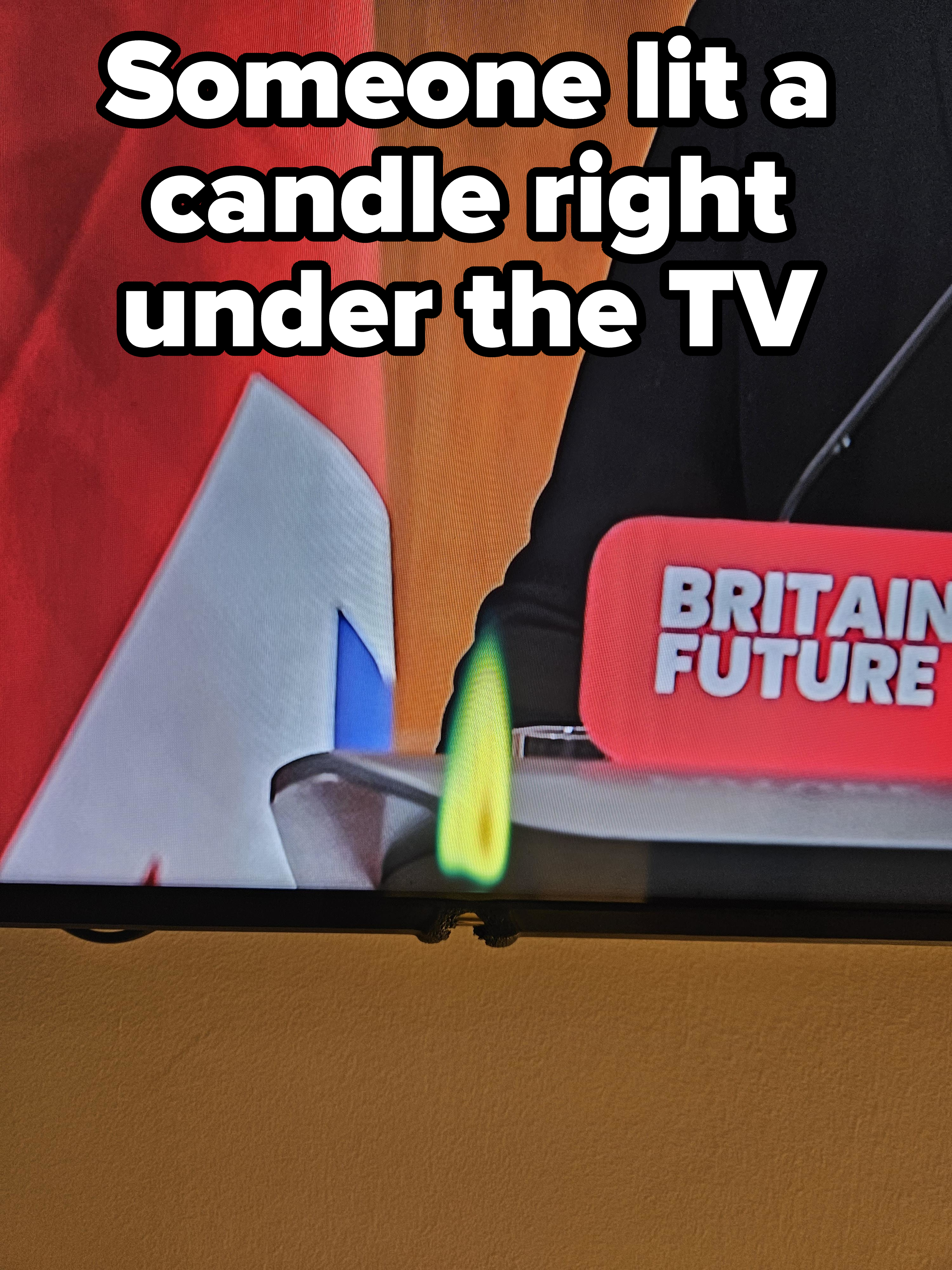 Close-up of a burned-out area of a TV screen in the shape of a flame, with caption, &quot;Someone lit a candle right under the TV&quot;