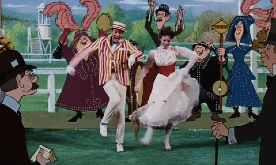 Bert and Mary Poppins dancing with others in a park scene. Mary wears a white dress; Bert is in a striped suit