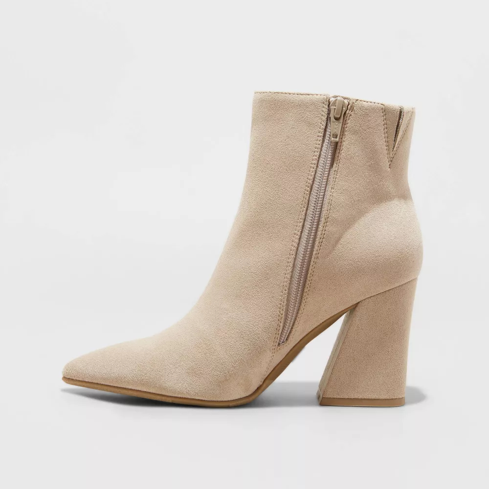 Beige ankle boot with a pointed toe and block heel.