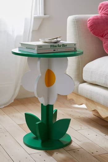 green white and yellow table with base shaped like daisy on stem