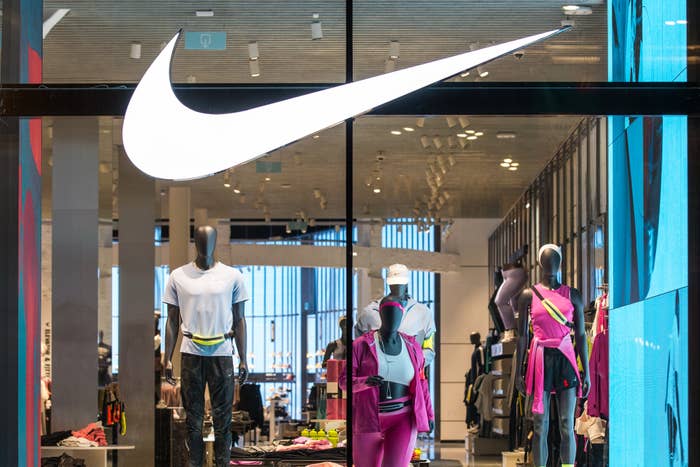 Nike store front with large logo and mannequins displaying sportswear inside