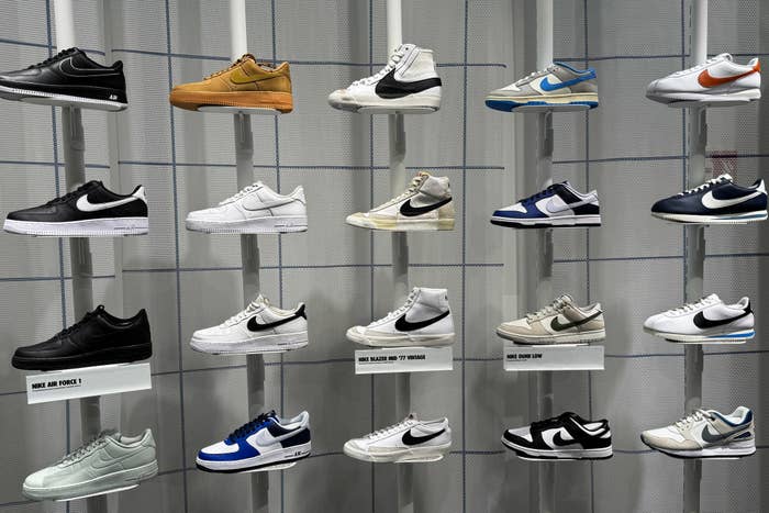 Variety of sneakers displayed on wall shelves, mainly in classic and sporty styles